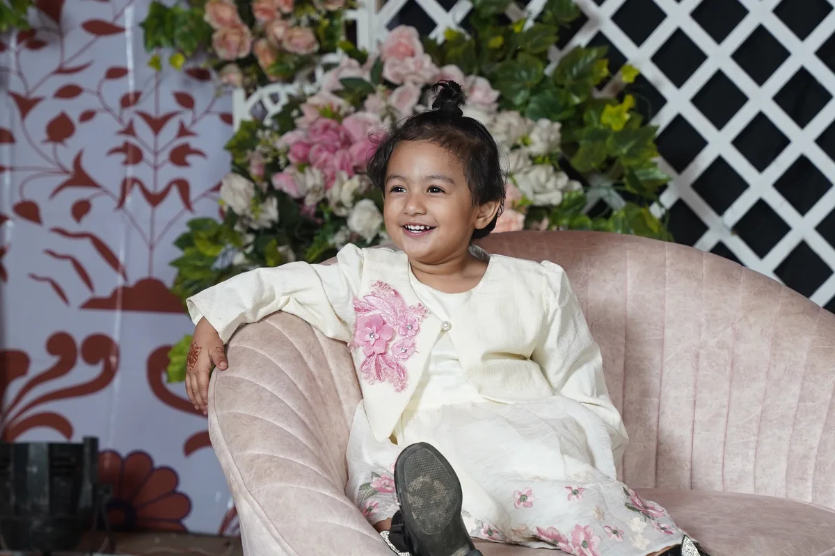 Jannat Fariha laughing on a sofa